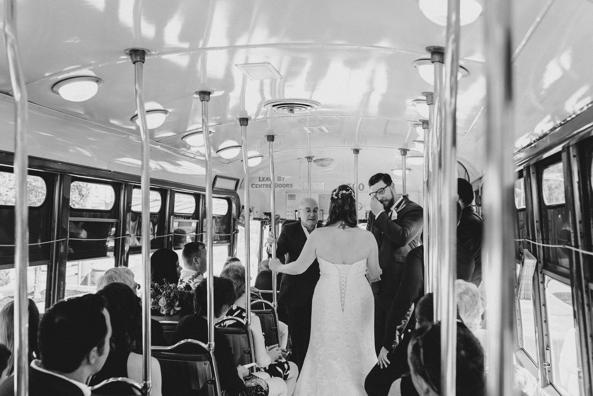 Black and white photo of the Groom crying during their Vintage Toronto Streetcar Wedding Ceremony
